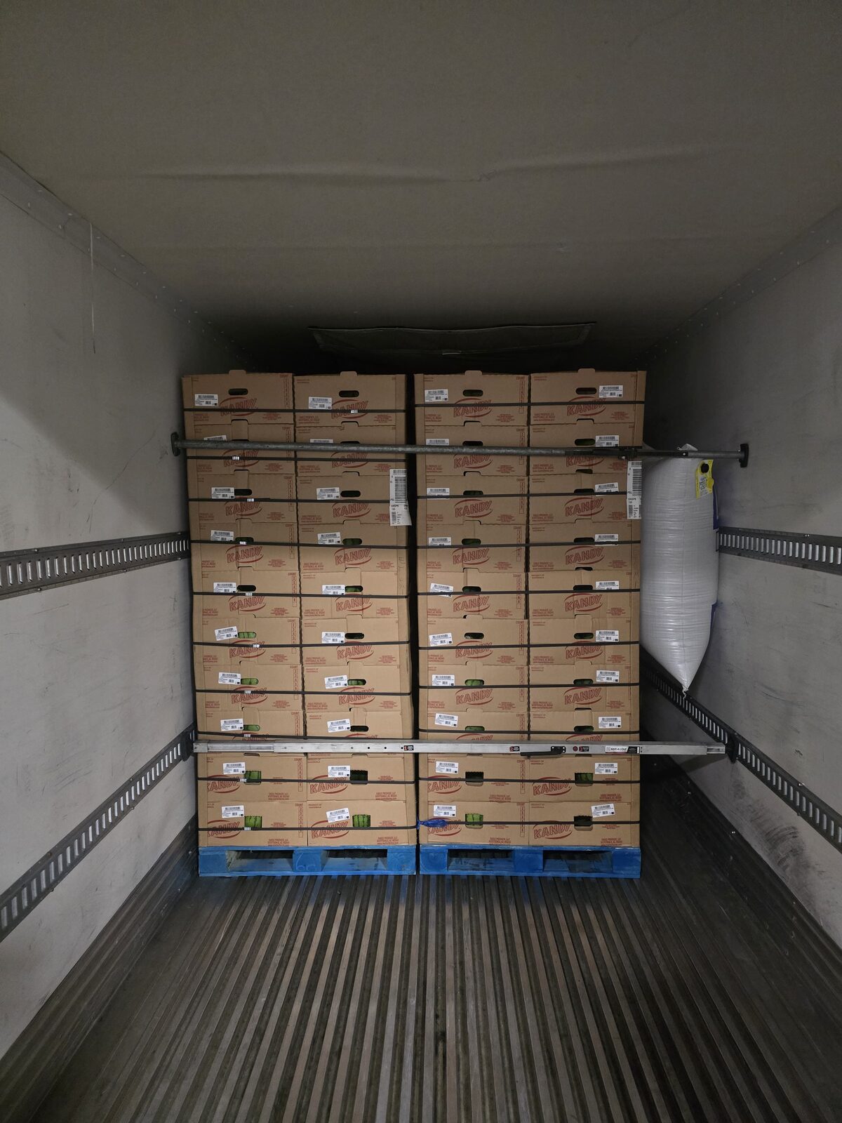 Cartons of fresh produce stacked inside a DT Trans LLC reefer trailer