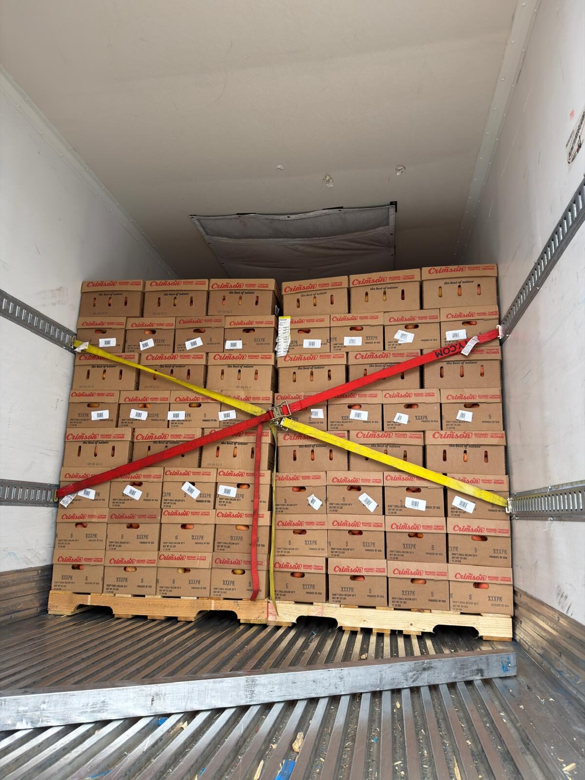 Cartons of Roma tomatoes secured inside a DT Trans LLC reefer trailer