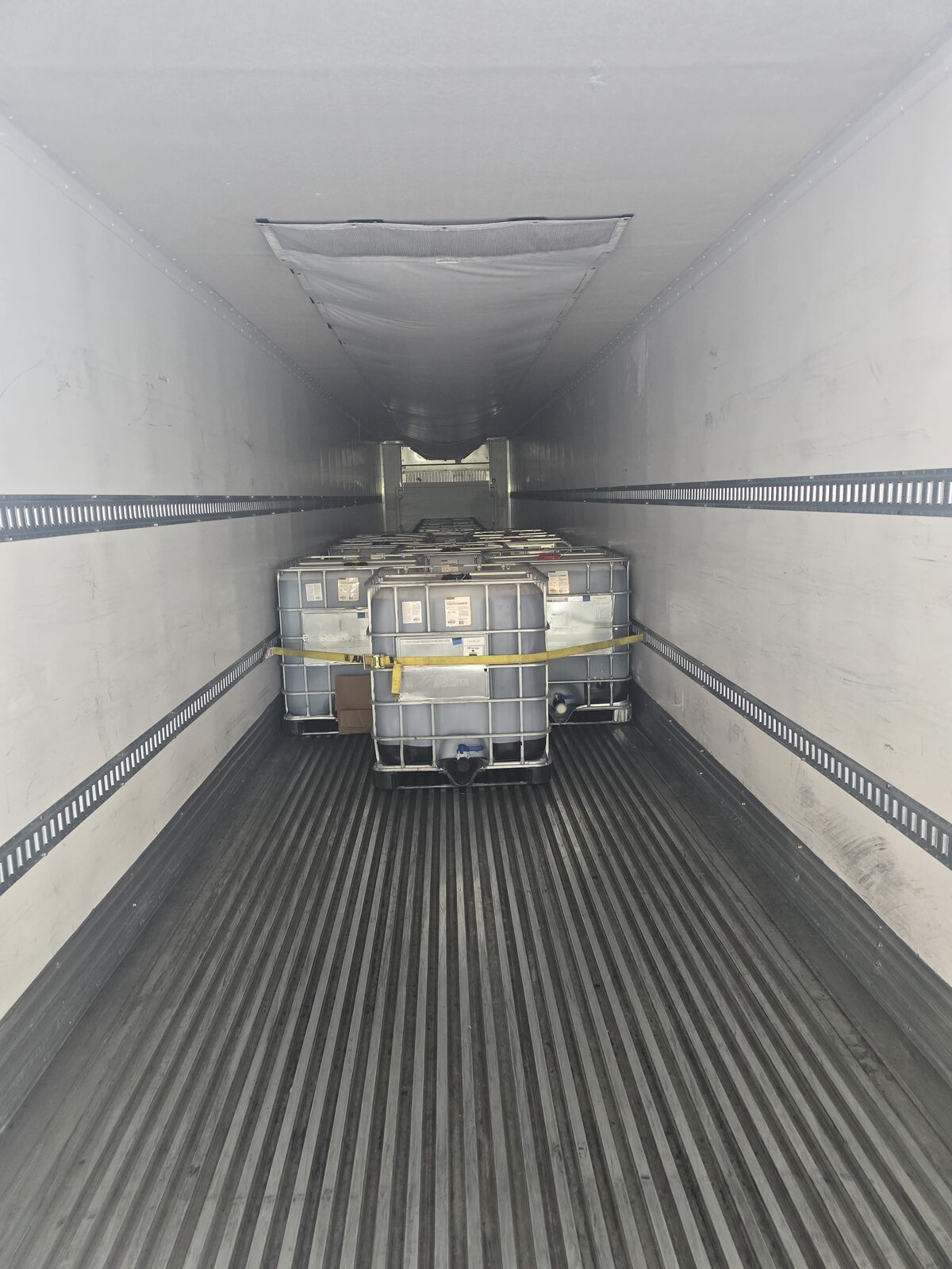 IBC totes secured inside a DT Trans LLC reefer trailer